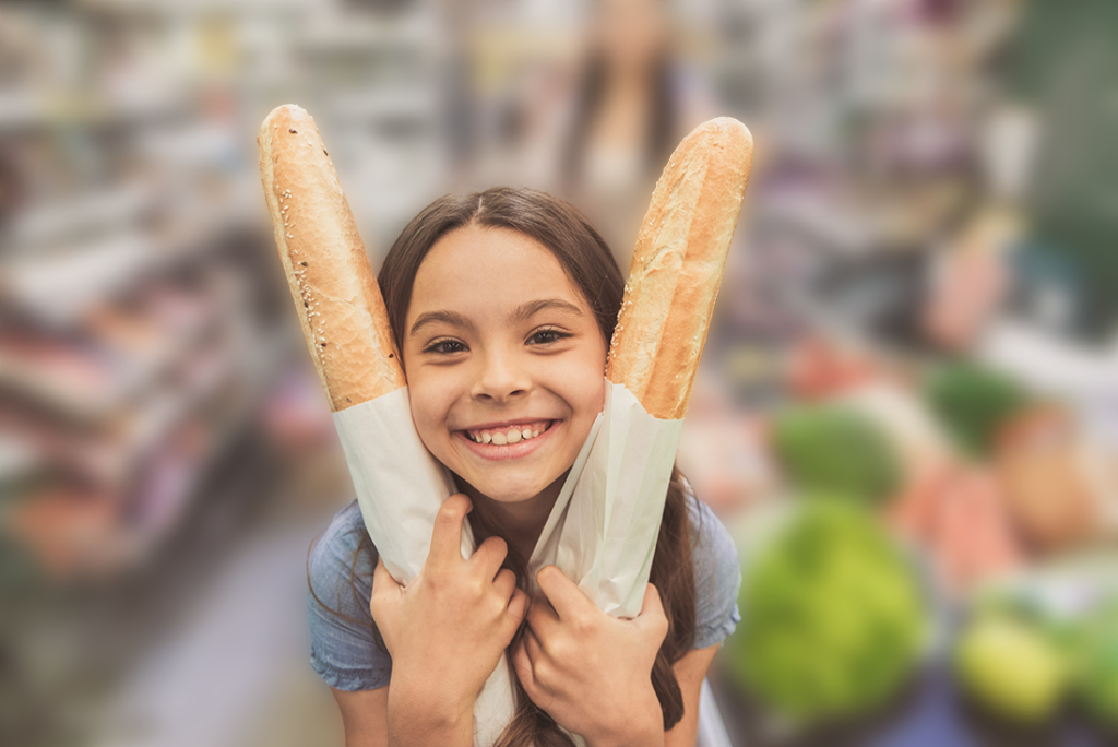 young girl holding baguettes