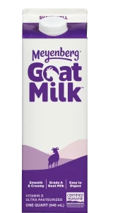 A carton of Meyenberg Goat Milk with a purple and white design, featuring the brand name and an illustration of a goat."